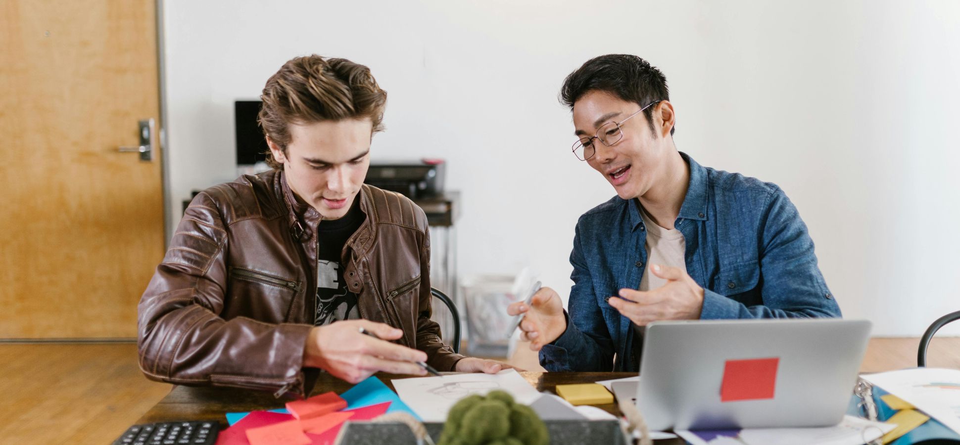 Two young cofounders talking to each other