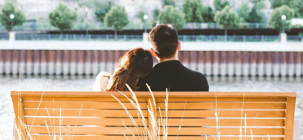 A couple sitting on a bench