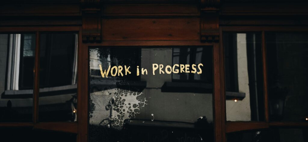 Window sign text work in progress dark background