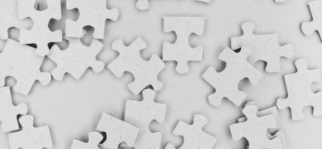Scattered blank puzzle pieces