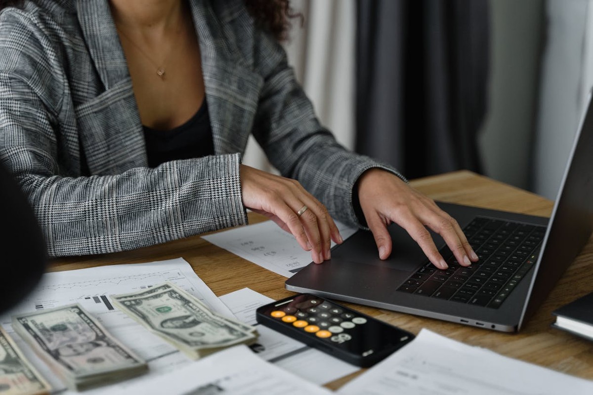 Entrepreneur reviewing startup costs and business plan on laptop