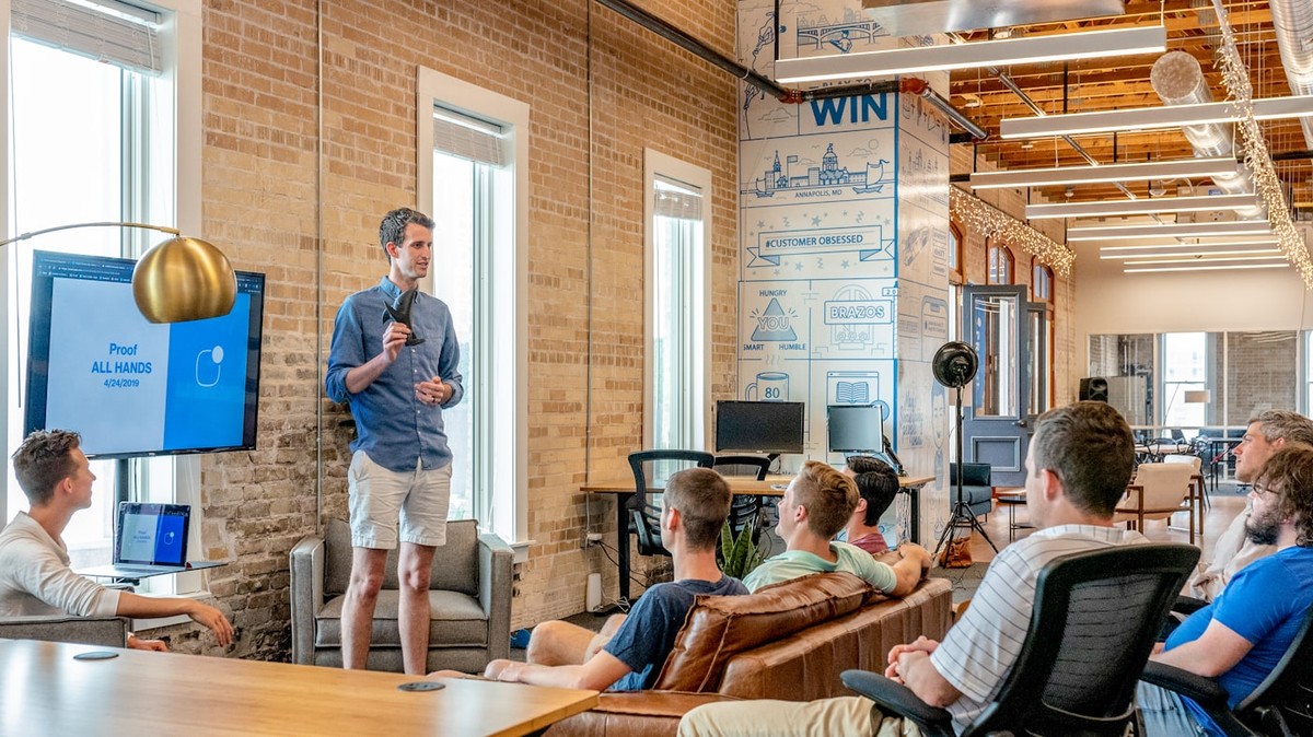 Entrepreneurs collaborating on TikTok marketing strategy in office