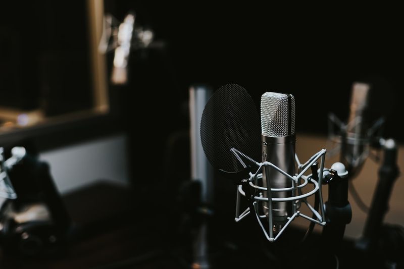 Bootstrapped founder listening to a business podcast with headphones while working