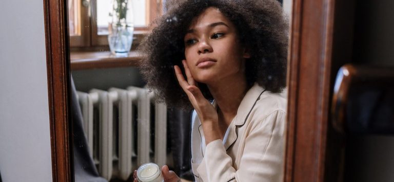 Woman applying skincare cream, Reale Actives Alix Earle acne skincare brand