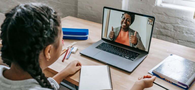 Student in an online tutoring side hustle video lesson with a tutor on a laptop in 2026