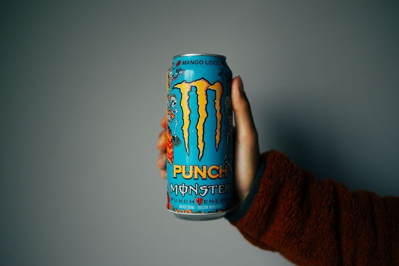 Caffeine-free paraxanthine energy drink can held in hand
