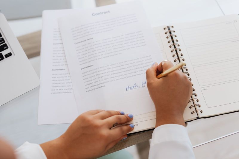 Signing a creator brand partnership contract showing commercial terms and commission clauses