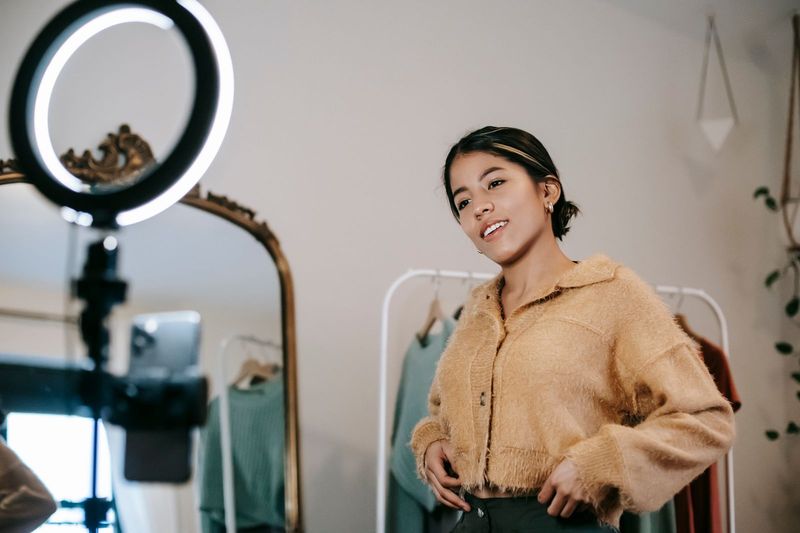 Creator filming a social commerce product review video with a ring light setup