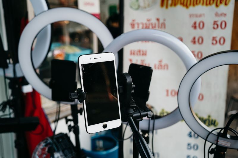 Phone on a tripod with ring lights, the kind of setup X creator monetization now rewards