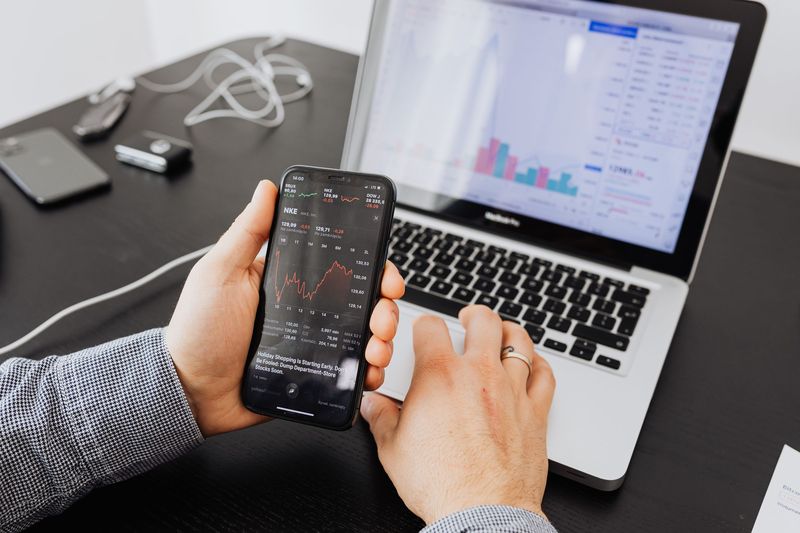 Creator reviewing analytics and payout data on a laptop and phone under X creator monetization rules