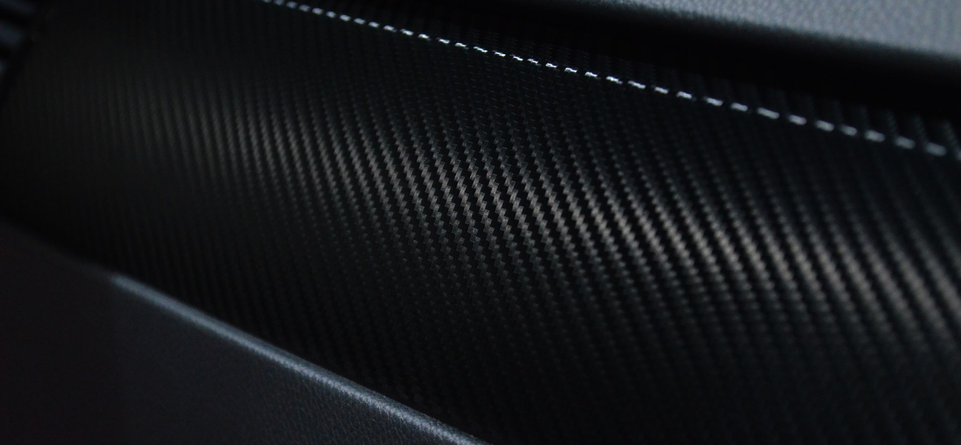 A close-up of black carbon fiber texture