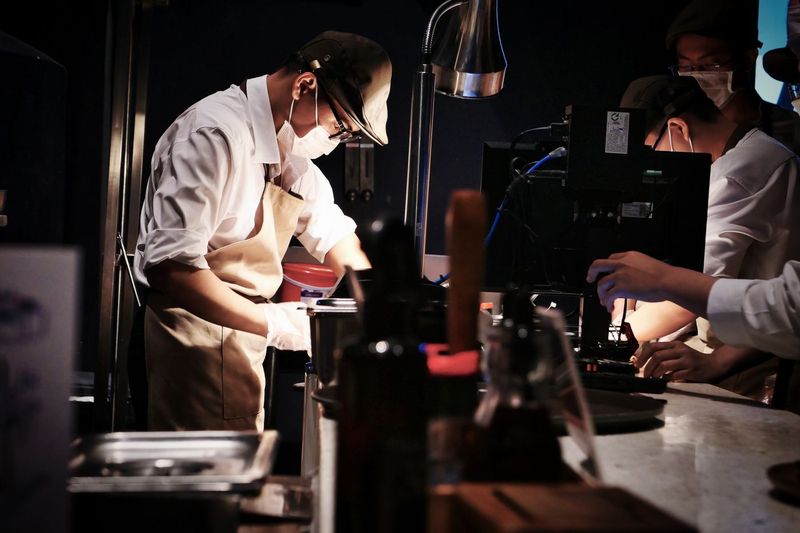 Kitchen staff cooking, the operating reality behind the celebrity restaurant business model