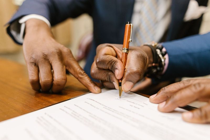 Signing a celebrity restaurant licensing deal contract at a table