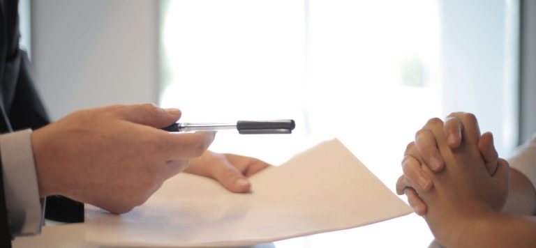Startup tender offer document and pen on a table as an employee decides whether to sell vested stock
