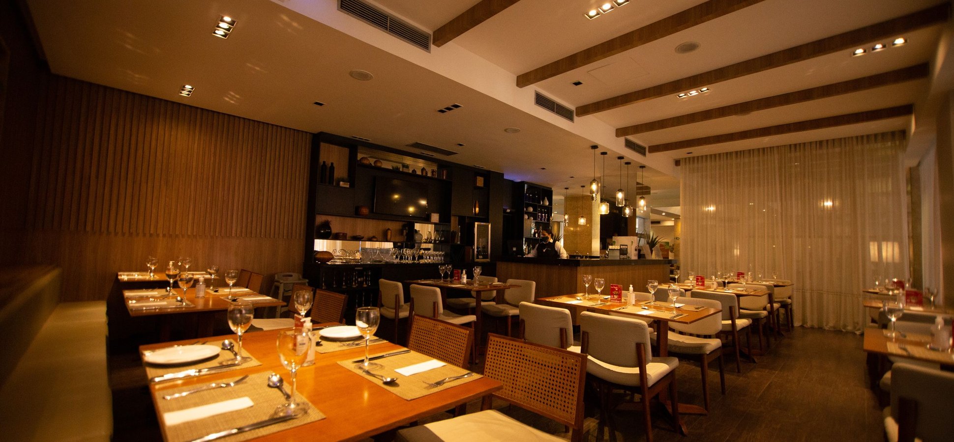 Empty set tables in a dining room, illustrating why celebrity restaurants fail